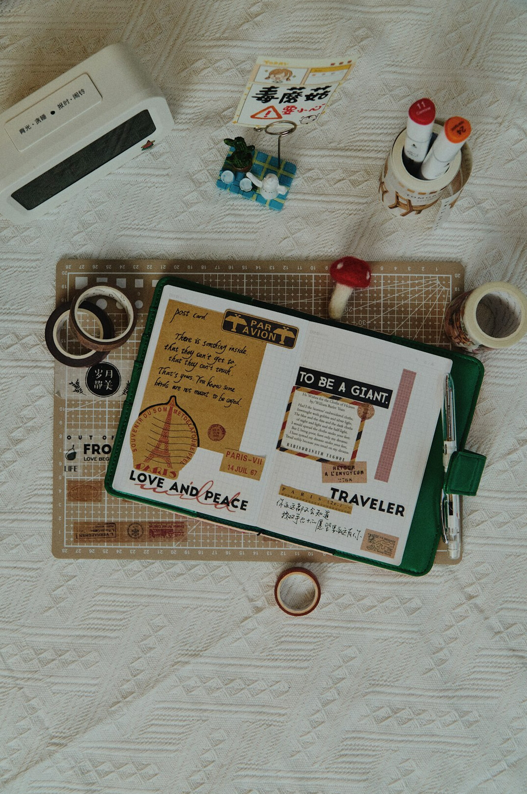 Open notebook with handwritten notes next to a laptop showing charts