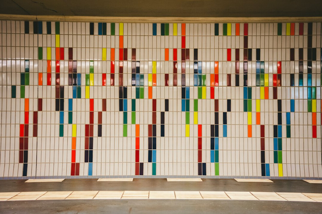 Large wall covered with printed statistical charts and colorful data visualizations